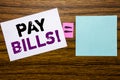 Handwriting Announcement text showing Pay Bills. Business concept for Finance Paying Online written on sticky note paper on wooden Royalty Free Stock Photo