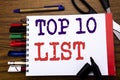 Handwriting Announcement text showing Top 10 Ten List. Business concept for Success ten list Written on notebook, wooden backgroun