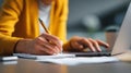 Handwriting notebook laptop office workspace woman writing notes while using computer Royalty Free Stock Photo