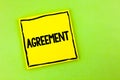 Handwriting text Agreement. Concept meaning Business or personal closures made easy with better guidance written on Yellow Sticky