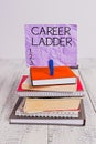 Handwriting text Career Ladder. Concept meaning Job Promotion Professional Progress Upward Mobility Achiever pile stacked books