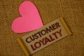 Handwriting text Customer Loyalty. Concept meaning Client Satisfaction Long-Term relation Confidence Ideas on old vintage paper bl Royalty Free Stock Photo