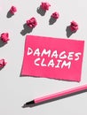 Handwriting text Damages Claim. Internet Concept Demand Compensation Litigate Insurance File Suit