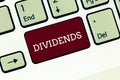 Handwriting text Dividends. Concept meaning sum of money paid regularly by company to shareholders out profits Keyboard