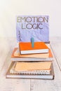 Handwriting text Emotion Logic. Concept meaning Heart or Brain Soul or Intelligence Confusion Equal Balance pile stacked books