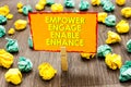 Handwriting text Empower Engage Enable Enhance. Concept meaning Empowerment Leadership Motivation Engagement Paperclip hold writte