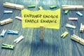 Handwriting text Empower Engage Enable Enhance. Concept meaning Empowerment Leadership Motivation Engagement Paperclip hold writte Royalty Free Stock Photo