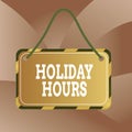 Handwriting text Holiday Hours. Concept meaning Overtime work on for employees under flexible work schedules Board attached string Royalty Free Stock Photo