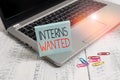 Handwriting text Interns Wanted. Concept meaning temporary position with an emphasis on the job training Trendy metallic laptop Royalty Free Stock Photo