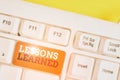 Handwriting text Lessons Learned. Concept meaning the knowledge or understanding gained by experience White pc keyboard Royalty Free Stock Photo