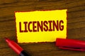 Handwriting text Licensing. Concept meaning Grant a license Legally permit the use of something Allow activity written on Yellow S Royalty Free Stock Photo