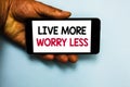 Handwriting text Live More Worry Less. Concept meaning Have a good attitude motivation be careless enjoy life Human hand hold mobi Royalty Free Stock Photo