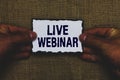 Handwriting text Live Webinar. Concept meaning Interactive seminar transmitted over the web Real Time Man holding piece paper blac