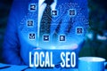 Handwriting text Local Seo. Concept meaning helps businesses promote products and services to local customers Male human