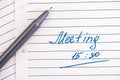 Handwriting text Meeting 15 30 on lined paper with pen