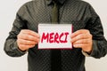 Handwriting text Merci. Concept meaning what is said or response when someone helps you in France Thank you Presenting