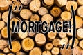 Handwriting text Mortgage. Concept meaning Conditional right of property to lender as warranty from loan Wooden background vintage