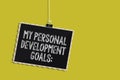 Handwriting text My Personal Development Goals. Concept meaning Desires Wishes Career Business planning Hanging blackboard message Royalty Free Stock Photo