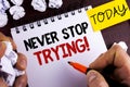Handwriting text Never Stop Trying Motivational Call. Concept meaning go on do not give up Self confidence written by Man on Notep Royalty Free Stock Photo