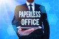 Handwriting text Paperless Office. Word Written on work environment in which the use of paper is eliminated Man In Royalty Free Stock Photo
