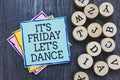 Handwriting text It s is Friday Let s is Dance. Concept meaning Celebrate starting the weekend Go party Disco Music Black wooden d