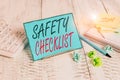 Handwriting text Safety Checklist. Concept meaning list of items you need to verify, check or inspect Notepaper stand on buffer