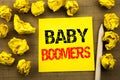 Handwriting text showing Baby Boomers. Business concept for Demographic Generation written on sticky note paper on the vintage bac