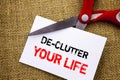 Handwriting text showing De-Clutter Your Life. Conceptual photo Free Less Chaos Fresh Clean Routine written on Sticky Note Paper C Royalty Free Stock Photo