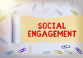 Handwriting text Social Engagement. Concept meaning Degree of engagement in an online community or society