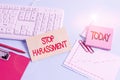 Handwriting text Stop Harassment. Concept meaning Prevent the aggressive pressure or intimidation to others Paper blue desk