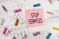 Handwriting text Stop Termites. Concept meaning prevent a small tropical insect from damaging the woods Colored clothespin Royalty Free Stock Photo