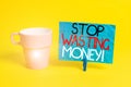 Handwriting text Stop Wasting Money. Concept meaning advicing demonstrating or group to start saving and use it wisely Royalty Free Stock Photo