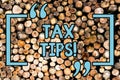 Handwriting text Tax Tips. Concept meaning compulsory contribution to state revenue levied by government Wooden