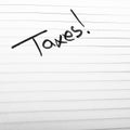 Handwriting text taxes on page of office agenda. Copy space