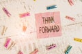 Handwriting text Think Forward. Concept meaning The act of thinking about and planning for the future Colored clothespin rectangle Royalty Free Stock Photo