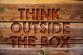 Handwriting text Think Outside The Box. Concept meaning Thinking of new and creative solution leads to success Wooden background v