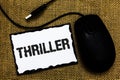Handwriting text Thriller. Concept meaning Chilling frightful moments in life film and movie category USB black mouse art board pa