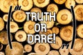 Handwriting text Truth Or Dare. Concept meaning Tell the actual facts or be willing to accept a challenge Wooden background