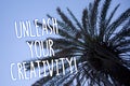 Handwriting text Unleash Your Creativity Call. Concept meaning Develop Personal Intelligence Wittiness Wisdom Tall palm tree blue Royalty Free Stock Photo