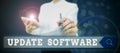 Text sign showing Update Software. Word for an application patch fixing the previouslyfound bugs Person holding