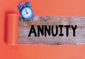 Handwriting text writing Annuity. Concept meaning fixed sum of money paid to someone each year Series of payments Alarm clock and Royalty Free Stock Photo