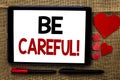 Handwriting text writing Be Careful. Concept meaning Caution Warning Attention Notice Care Beware Safety Security written on Table Royalty Free Stock Photo