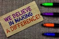 Handwriting text writing We Believe In Making A Difference. Concept meaning self-confidence that can be unique Paperboard computer