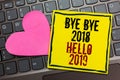 Handwriting text writing Bye Bye 2018 Hello 2019. Concept meaning Starting new year Motivational message 2018 is over Written on b Royalty Free Stock Photo