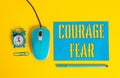 Handwriting text writing Courage Fear. Concept meaning quality of mind that enables a demonstrating to face difficulty Paper sheet