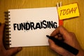 Handwriting text writing Fundraising. Concept meaning Seeking of financial support for charity cause or enterprise Man hold holdin Royalty Free Stock Photo