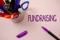 Handwriting text writing Fundraising. Concept meaning Seeking of financial support for charity cause or enterprise White backgroun