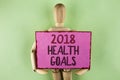 Handwriting text writing 2018 Health Golas. Concept meaning new year plan Workout healthy food Resolution goals written on Sticky Royalty Free Stock Photo