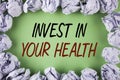 Handwriting text writing Invest In Your Health. Concept meaning Spend money in personal healthcare Preventive Tests written on pla