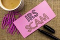 Handwriting text writing Irs Scam. Concept meaning Warning Scam Fraud Tax Pishing Spam Money Revenue Alert Scheme written on Pink Royalty Free Stock Photo